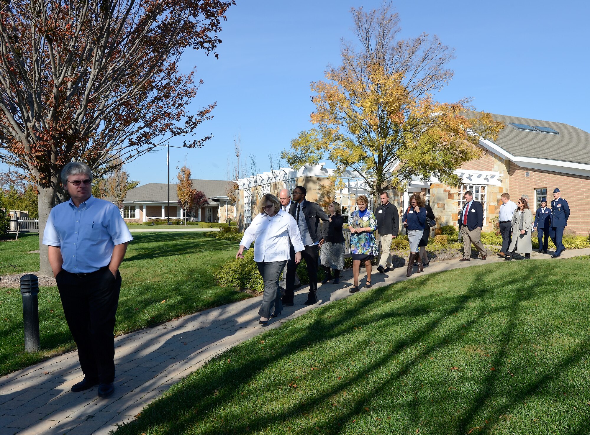 Local business and civic leaders walk along the path to the meditation garden during a tour of the Fisher House on Nov. 10, 2014, at Dover Air Force Base, Del. The tour was part of the 2014 Military Construction Breakfast hosted by the Central Delaware Chamber of Commerce.  (U.S. Air Force photo/Greg L. Davis)      