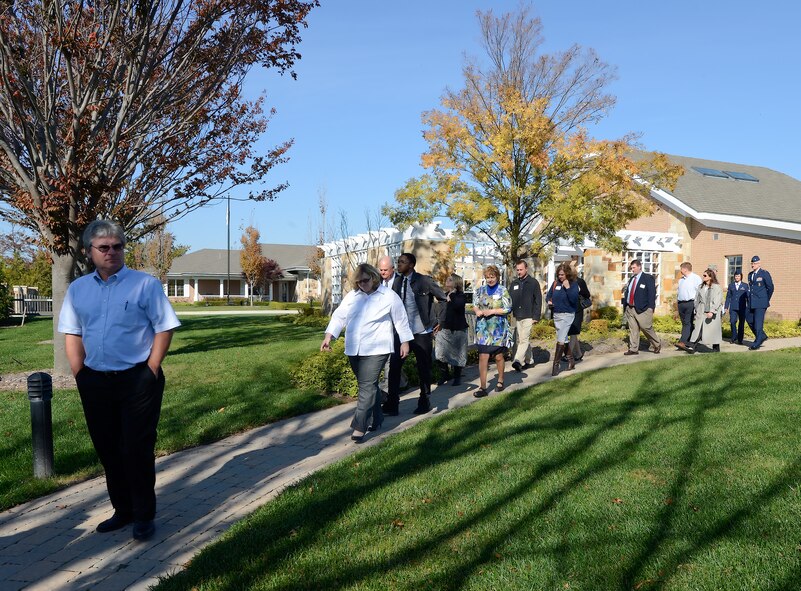 Local business and civic leaders walk along the path to the meditation garden during a tour of the Fisher House on Nov. 10, 2014, at Dover Air Force Base, Del. The tour was part of the 2014 Military Construction Breakfast hosted by the Central Delaware Chamber of Commerce.  (U.S. Air Force photo/Greg L. Davis)      