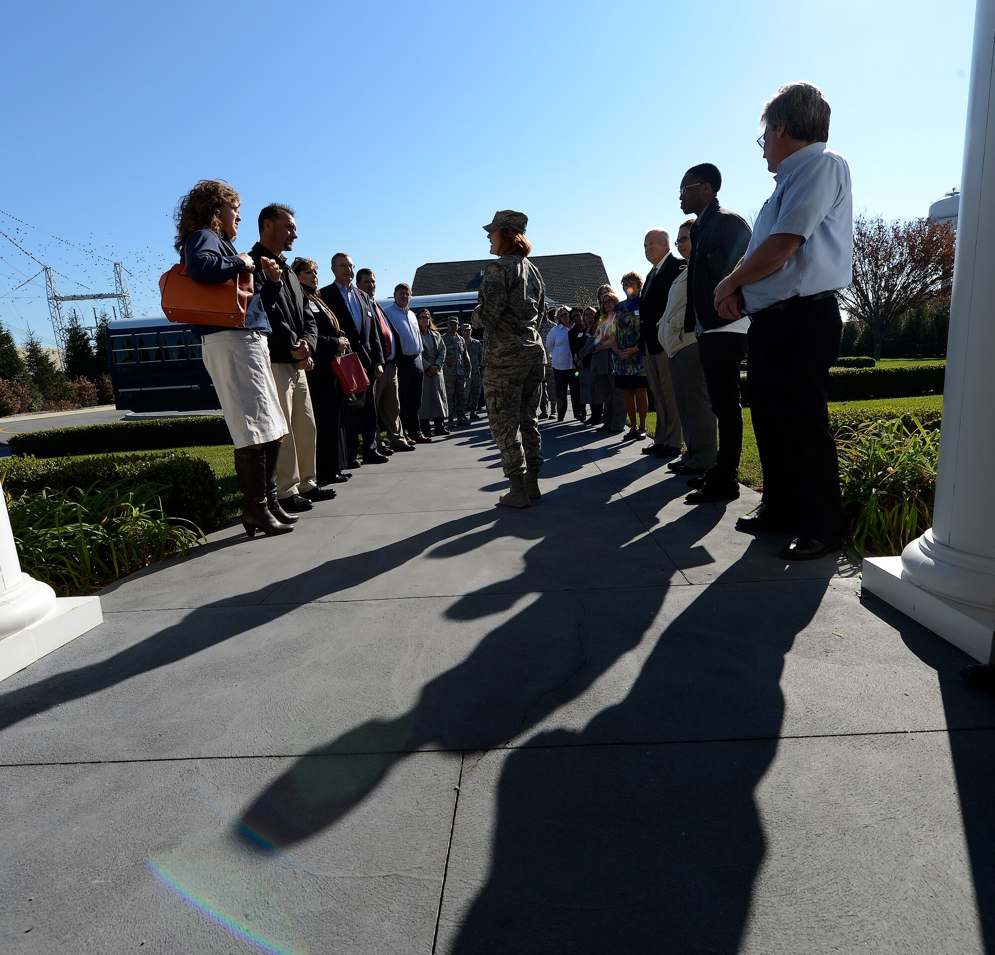 Long shadows fall on the walkway to the Fisher House at Dover Air Force Base, Del., as a group of dignitaries prepare to tour the facility on Nov. 10, 2014. The Fisher House is used to accommodate family members who come to the base to witness the return of loved-ones killed-in-action overseas. (U.S. Air Force photo/Greg L. Davis)      