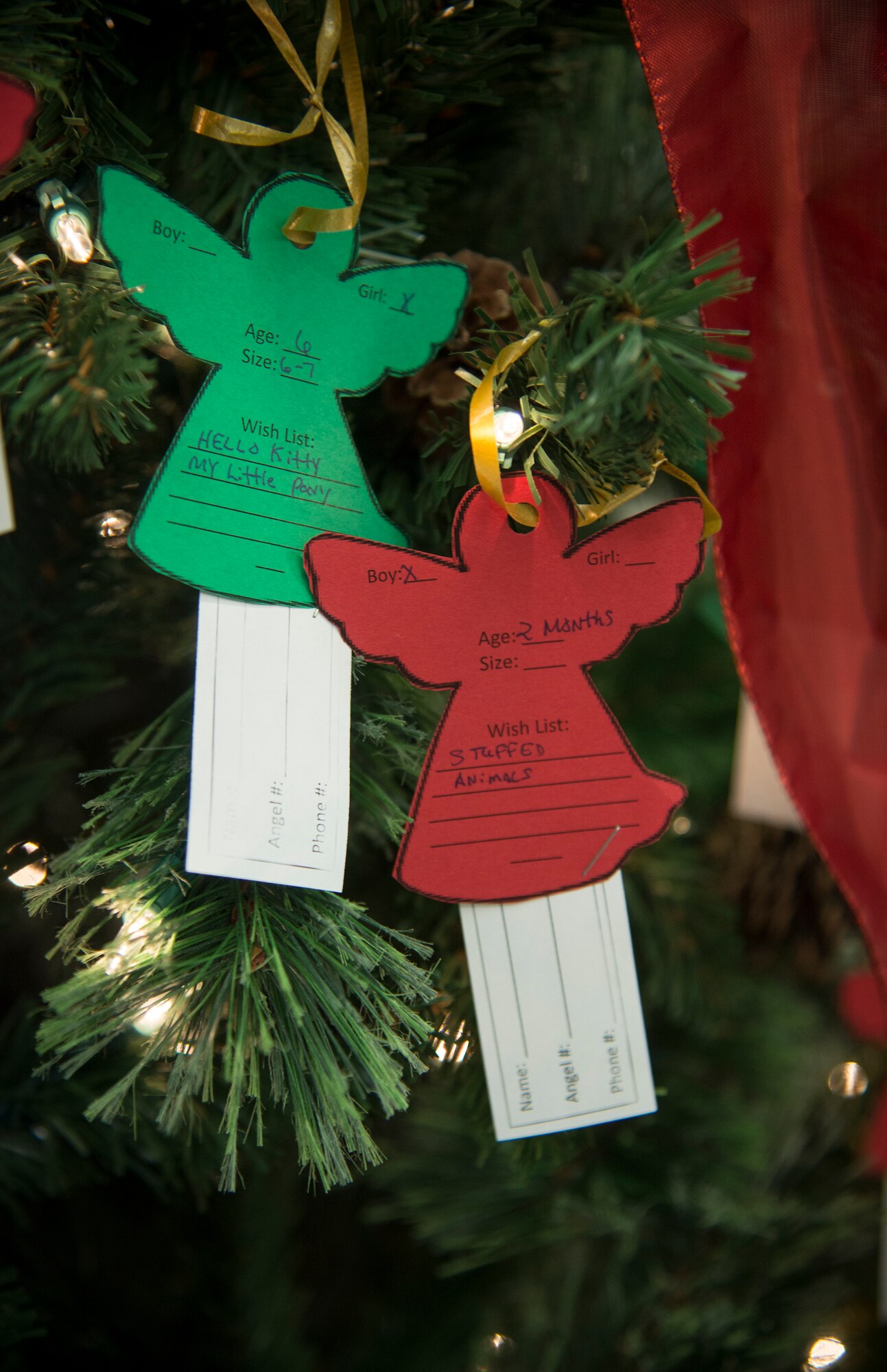 Ornaments hang from a tree Nov. 17, 2014 during the Angel Tree Project unveiling at Moody Air Force Base, Ga. Team Moody members can pick up ornaments at the base exchange and Airman and Family Readiness Center until Dec. 12 to donate a holiday gift to a child. (U.S. Air Force photo by Senior Airman Sandra Marrero/Released)
