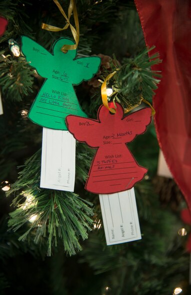 Ornaments hang from a tree Nov. 17, 2014 during the Angel Tree Project unveiling at Moody Air Force Base, Ga. Team Moody members can pick up ornaments at the base exchange and Airman and Family Readiness Center until Dec. 12 to donate a holiday gift to a child. (U.S. Air Force photo by Senior Airman Sandra Marrero/Released)
