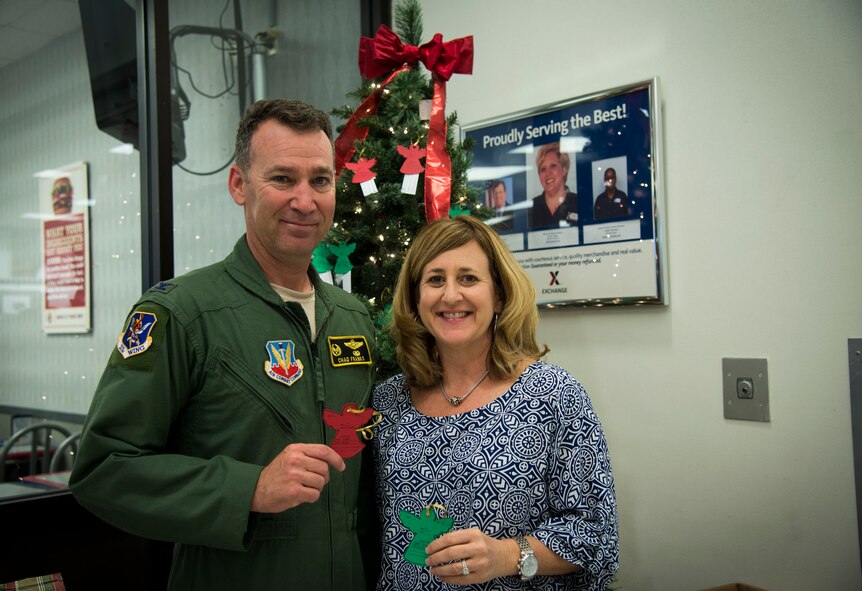 U.S. Air Force Col. Chad Franks, 23d Wing commander and wife Kim Franks pose for a photo during the Angel Tree Project unveiling Nov. 17, 2014. Franks and his wife picked the first ornaments to donate gifts to the children of Moody Airmen. (U.S. Air Force photo by Senior Airman Sandra Marrero/Released)
