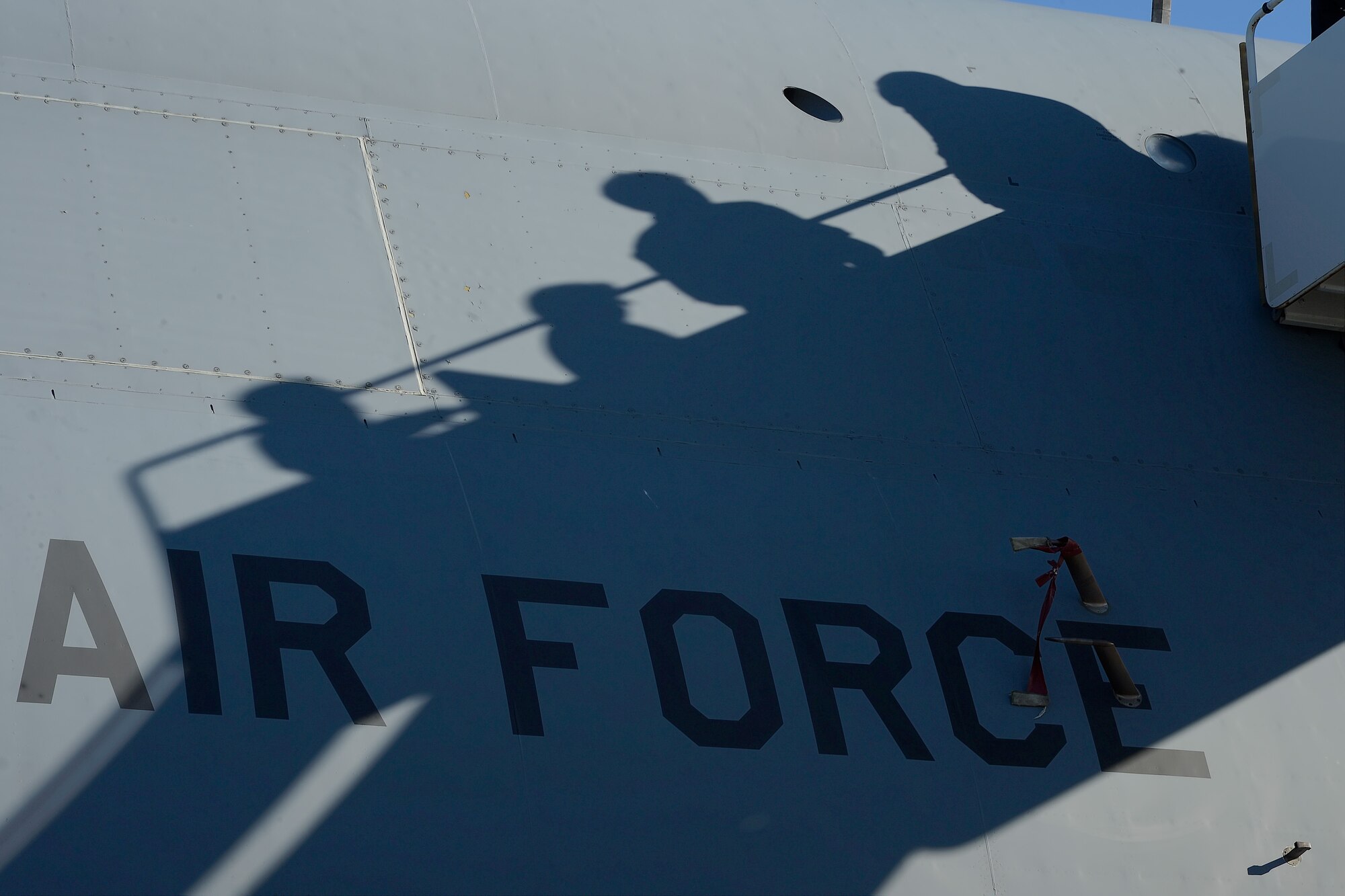 Shadows are cast on the fuselage of a C-5M Super Galaxy of the 436th Airlift Wing as personnel board the aircraft on Nov. 10, 2014, at Dover Air Force Base, Del. The C-5M is the Air Force???s largest, heavy-lift transport aircraft in the inventory. (U.S. Air Force photo/Greg L. Davis)