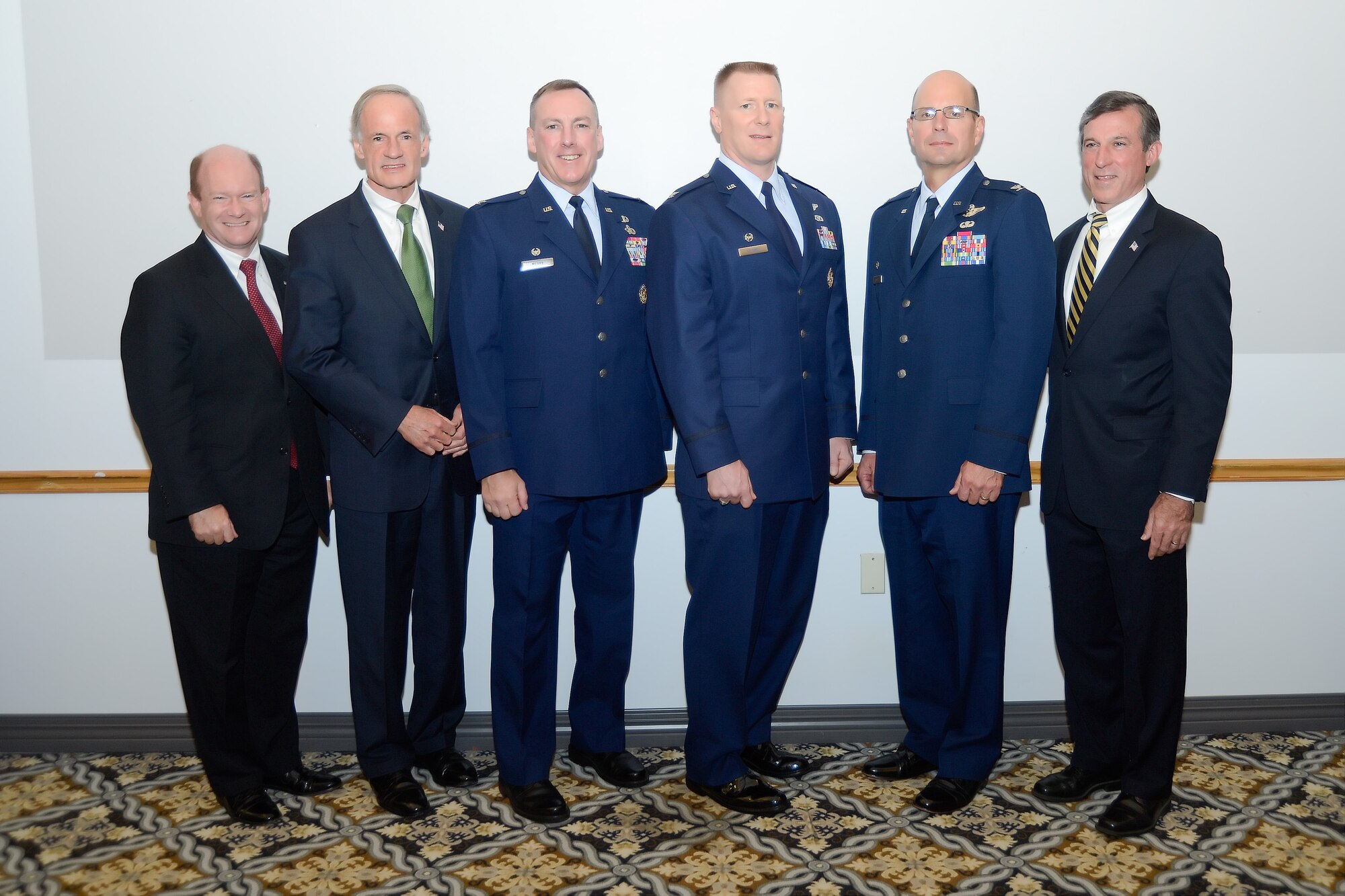 Three senior military officers at Dover Air Force Base, Del. are joined by elected Reps. from Delaware following the 2014 Military Construction Breakfast on Nov. 10, 2014. From left to right are: Sens. Chris A. Coons, Thomas R. Carper, Col. Daniel F. Merry, Air Force Mortuary Affairs Operations commander, Col. Michael Grismer, 436th Airlift Wing commander, Col. Raymond Kozak, 512th Airlift Wing commander, Air Force Reserve Command and Rep. John C. Carney Jr. (U.S. Air Force photo/Greg L. Davis)  