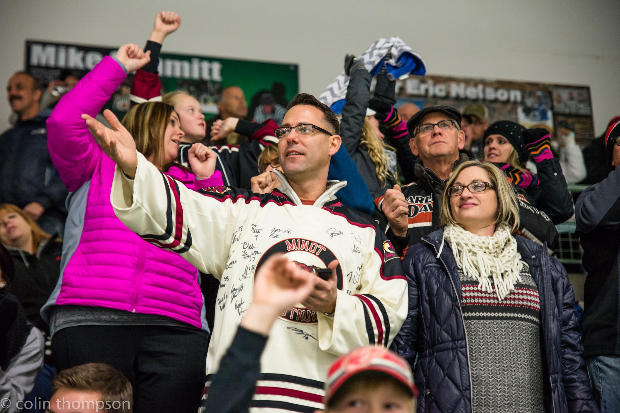 Senior Master Sgt. John Lium, 5th Aircraft Maintenance Squadron sortie support superintendent, watches a hockey game in Minot, N.D., Nov. 11, 2014. The teams let Lium drop the puck to honor him for his upcoming retirement and to thank him for his volunteer work with the team. (Courtesy photo) 