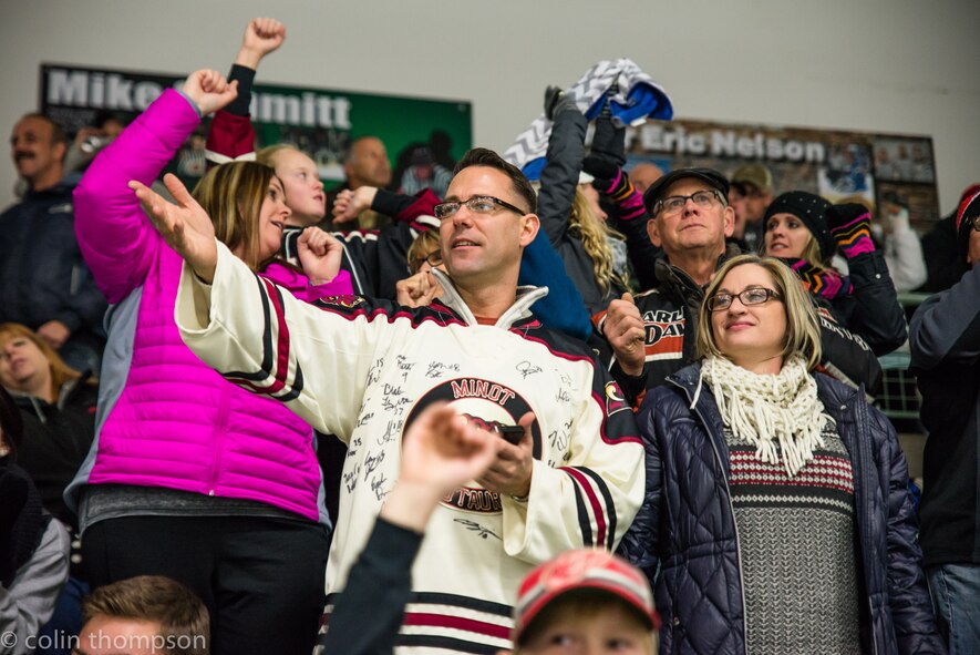 Senior Master Sgt. John Lium, 5th Aircraft Maintenance Squadron sortie support superintendent, watches a hockey game in Minot, N.D., Nov. 11, 2014. The teams let Lium drop the puck to honor him for his upcoming retirement and to thank him for his volunteer work with the team. (Courtesy photo) 