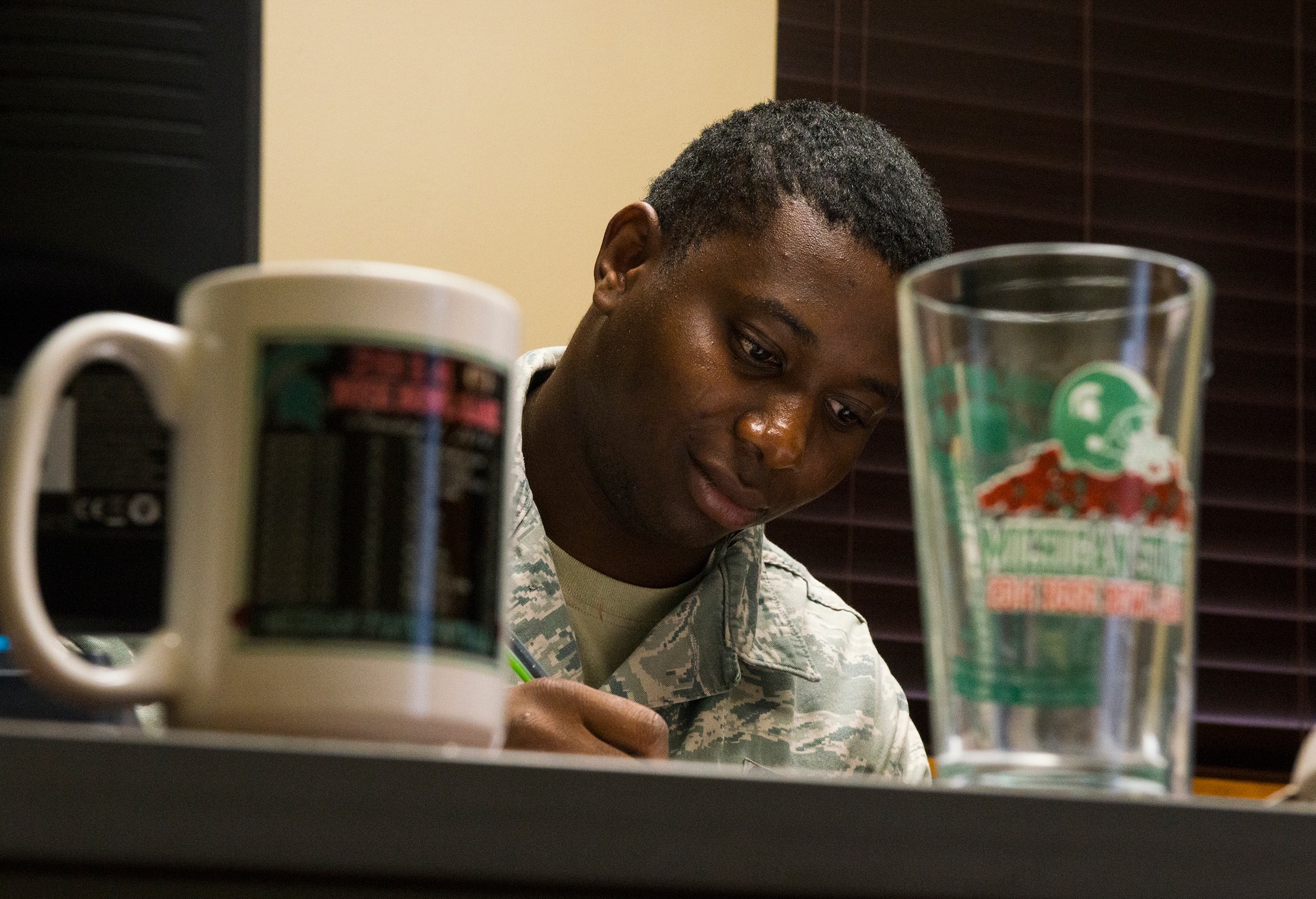 U.S. Air Force Senior Airman Wallis Iduoze, 23d Logistics Readiness Squadron fuels distribution operator, reviews an enlisted performance report (EPR) during the “Walk a Day in My Shoes” fundraiser Nov. 13, 2014, at Moody Air Force Base, Ga.  Idouze was in charge of an entire flight while performing tasks such as writing EPRs and attending briefings. (U.S. Air Force photo by Airman 1st Class Ceaira Tinsley/Released)