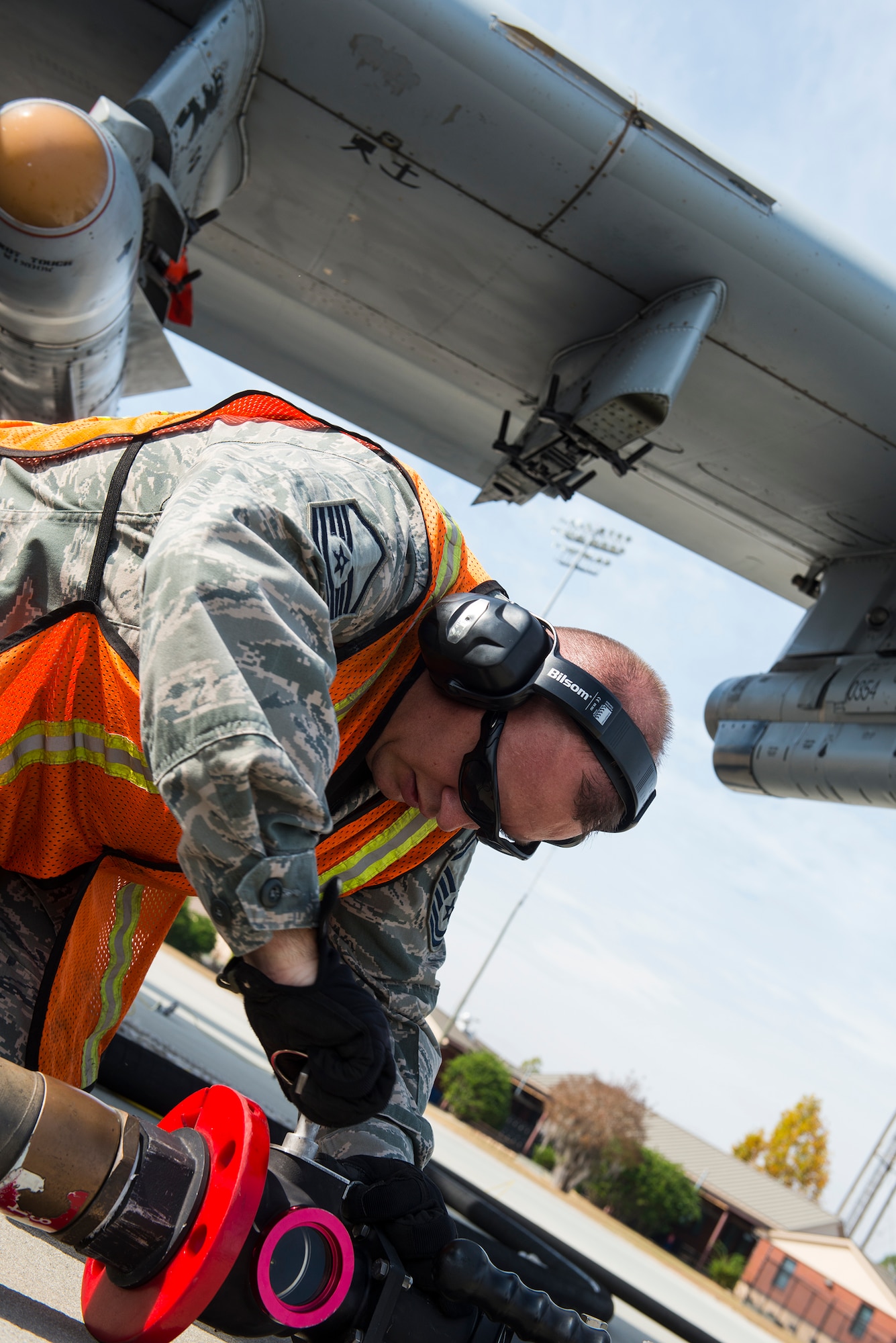 U.S. Air Force Master Sgt. Michael Dunblazier, 23d Logistics Readiness Squadron operations section chief, tightens a strainer during the “Walk a Day in My Shoes” fundraiser Nov. 13, 2014, at Moody Air Force Base, Ga. Dunblazier traded his office job to refuel aircraft on the flightline as a fuels distribution operator. (U.S. Air Force photo by Airman 1st Class Ceaira Tinsley/Released)