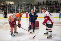 Senior Master Sgt. John Lium, 5th Aircraft Maintenance Squadron sortie support superintendent, drops a puck at the Minot Minotauros hockey game in Minot, N.D., Nov. 11, 2014. The teams let Lium drop the puck to honor him for his upcoming retirement and to thank him for his volunteer work with the team. (Courtesy photo) 