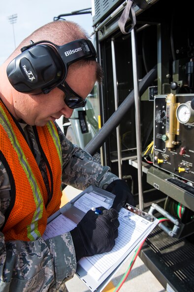 U.S. Air Force Master Sgt. Michael Dunblazier, 23d Logistics Readiness Squadron operations section chief, fills out paperwork during the “Walk a Day in My Shoes” fundraiser Nov. 13, 2014, at Moody Air Force Base, Ga.  Dunblazier hadn’t worked in an entry level position in 13 years prior to the swap. (U.S. Air Force photo by Airman 1st Class Ceaira Tinsley/Released)