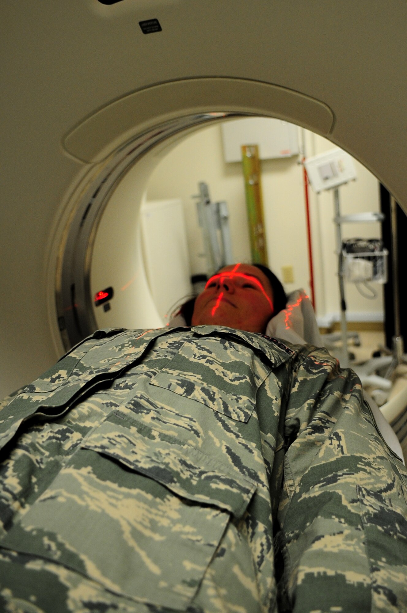 U.S. Air Force Tech. Sgt. Danielle McAtee, 633rd Surgical Operations Squadron diagnostic imaging core section chief, receives a computed tomography scan at Langley Air Force Base, Va., Nov. 14, 2014. A CT scan is a noninvasive medical examination that uses specialized X-ray equipment to produce cross-sectional images of the body. (U.S. Air Force photo by Airman 1st Class Areca T. Wilson/Released) 