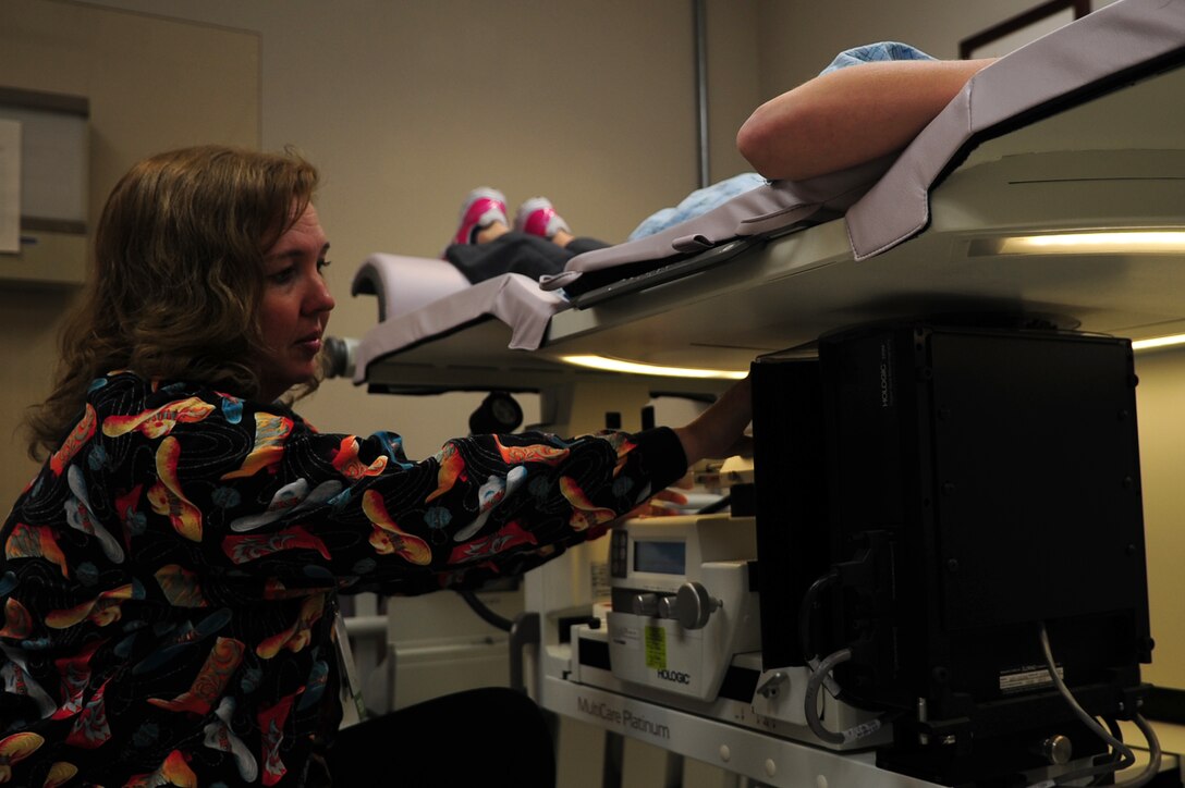 Wendy Elvis, 633rd Surgical Operations Squadron mammography lead technologist, performs a biopsy on a patient at Langley Air Force Base, Va., Nov. 14, 2014. During a biopsy, a small sample of breast tissue is removed for laboratory testing to evaluate a suspicious area, to determine if a cancer is present. (U.S. Air Force photo by Airman 1st Class Areca T. Wilson/Released) 