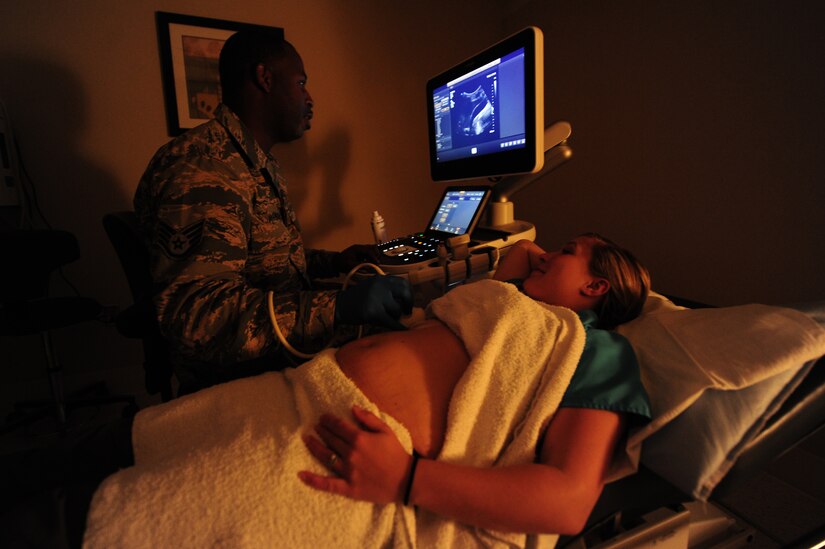 U.S. Air Force Staff Sgt. Thomas Wright, 633rd Surgical Operations Squadron diagnostics medical sonographer, performs an ultrasound on Sara Cearnel, 633rd SGCS diagnostics medical sonographer, at Langley Air Force Base, Va., Nov. 14, 2014. Ultrasounds use high-frequency sound waves to look at organs and structures inside the body. (U.S. Air Force photo by Airman 1st Class Areca T. Wilson/Released) 