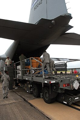 Airmen from the 25th Aerial Port Squadron load a C-130 with humanitarian supplies, ultimately bound for Honduras. 