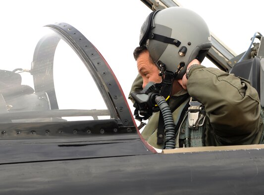 U.S. Air Force Lt. Col. August Marquardt, Air Combat Command F-35 Lightning requirements officer, dons his helmet before piloting a T-38 Talon for a training mission at Langley Air Force Base, Va., Nov. 17, 2014. Talons act as adversary fighters to the F-22 Raptors during training. (U.S. Air Force photo by Senior Airman Austin Harvill/Released)
