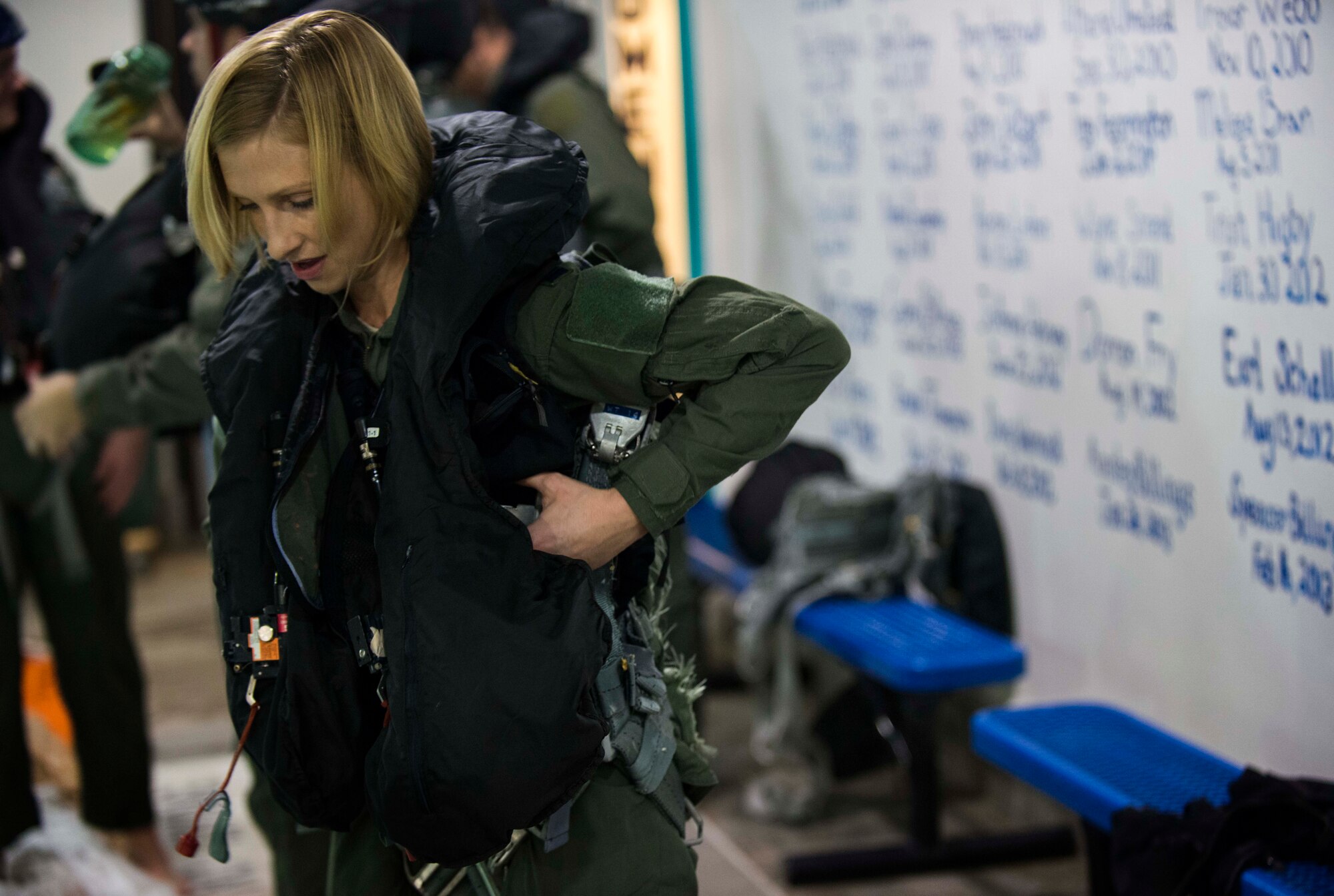 Capt. Christin Masstracchio, 69th Bomb Squadron assistant flight commander, secures her life vest before a water-survival training course on Minot Air Force Base, Nov. 4, 2014. The course prepares and trains aviators on the proper techniques of survival in the event their aircraft went down over water, or enemy territory. (U.S. Air Force photo/Airman 1st Class Lauren Pitts) 