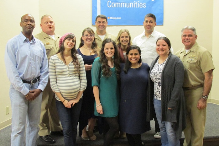 Capt. Timothy Sparks, Joint Base Charleston deputy commander (right), Cmdr. David Tarwater, Naval Support Activity executive officer (center) and Master Chief Petty Officer Joseph Gardner, NSA command master chief (second from left) join Navy and Marine Corps Relief Society volunteers (left to right) Marquis Patton, Summer Willcox, Talitha Robertson, Amanda Roberts, Taylor Brockman, Monica Jatho, Sean Moaratty and Annikah Moaratty, NMCRS relief services assistant, for a holiday dinner Nov. 8, 2014, at the Balfour Beatty Community Center at the Weapons Station. The Navy and Marine Relief Society helped 486 clients receive more than $300,000 in assistance in 2014. The NMCRS is always looking for dedicated, service-oriented people to help local military families. If you are interested in volunteering with NMCRS,  call 794-7662 to set up an interview. (U.S. Navy photo/Brenda Sparks)

