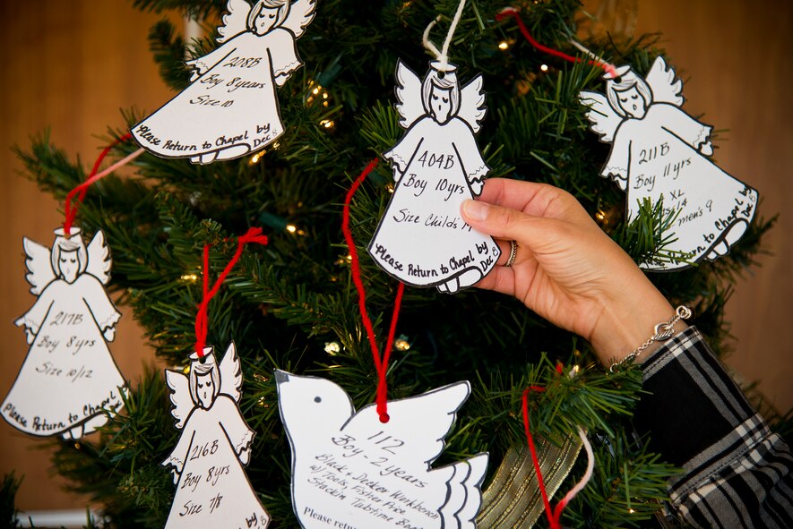 An "Angel" request is chosen from one of four Angel Tree locations at Eglin Air Force Base, Fla.  The Chapel's Angel Tree program is going on now through Dec. 8 when all presents have to be turned back in.  Anyone who wants to fulfill a Christmas wish of a needy child only has to pick the Angel or Dove request from one of the trees.  For more information, call 882-2111.  (U.S. Air Force photo/Samuel King Jr.)