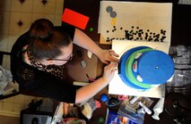 Staff Sgt. Jean Lawrence, prior 436th Operation Support Group unit deployment manager, adds details to a cake Nov. 7, 2014 at her home in Magnolia, Del. Lawrence, who is being medically retired from the Air Force, has a passion for making and decorating cakes. (U.S. Air Force photo/Staff Sgt. Elizabeth Morris)