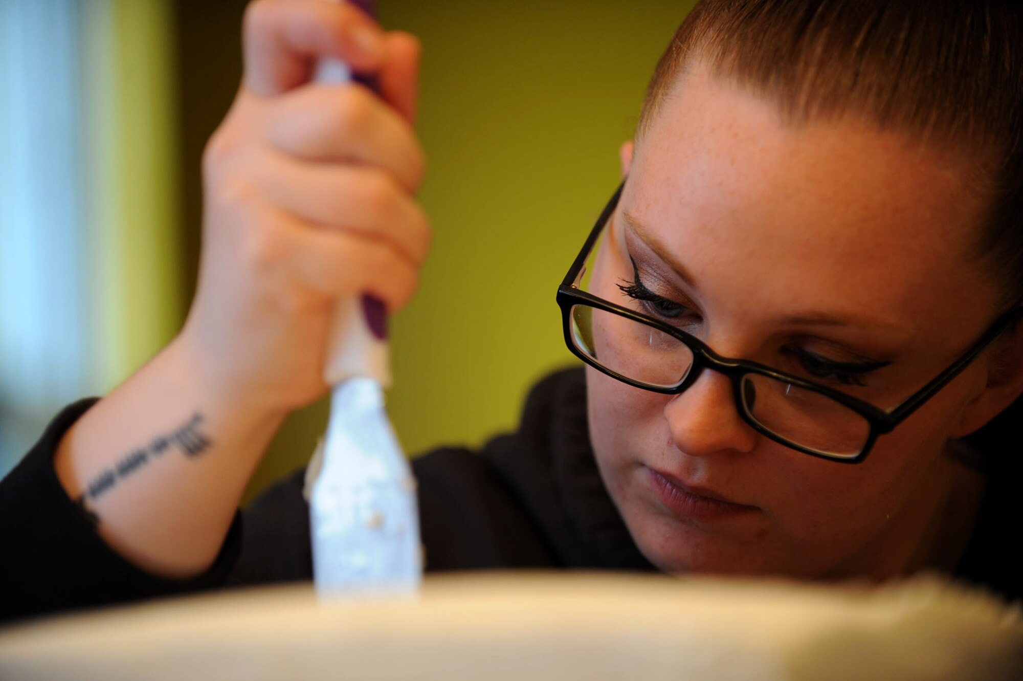Staff Sgt. Jean Lawrence, prior 436th Operation Support Group unit deployment manager, ices a cake Nov. 5, 2014 at her home in Magnolia, Del. Lawrence has been able to apply lessons she's learned in the Air Force to help her in her cake business. (U.S. Air Force photo/Staff Sgt. Elizabeth Morris)