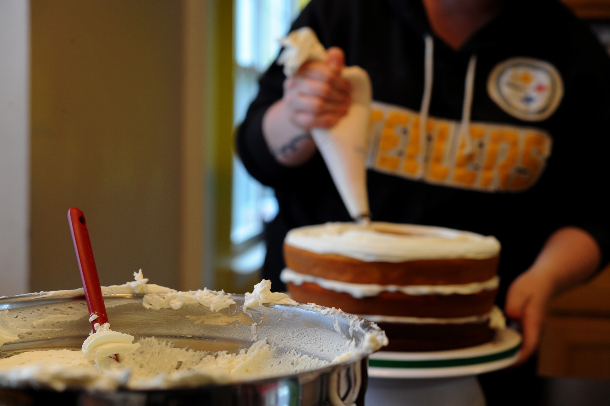 Staff Sgt. Jean Lawrence, prior 436th Operation Support Group unit deployment manager, ices a cake Nov. 5, 2014 at her home in Magnolia, Del. Lawrence will have served over ten years in the Air Force by the time she is medically retired. (U.S. Air Force photo/Staff Sgt. Elizabeth Morris)
