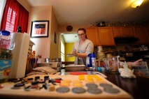 Staff Sgt. Jean Lawrence, prior 436th Operation Support Group unit deployment manager, adds a layer of powdered sugar to a cake prior to baking it Nov. 4, 2014 at her home in Magnolia, Del. Cake making and decorating have been a positive outlet for Lawrence, who is being medically retired from the Air Force at the end of this year. (U.S. Air Force photo/Staff Sgt. Elizabeth Morris)