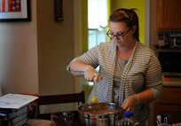 Staff Sgt. Jean Lawrence, prior 436th Operation Support Group unit deployment manager, adds an egg to cake batter Nov. 4, 2014 at her home in Magnolia, Del. Lawrence has a passion for making cakes and has been creating them since 2011. (U.S. Air Force photo/Staff Sgt. Elizabeth Morris)