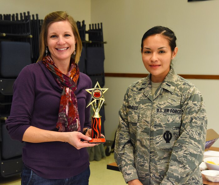 Jennifer Sundy, military spouse (left), stands with 1st Lt. Mayrem Morales, 10th Missile Squadron deputy combat missile crew commander, after taking first place in the people’s choice category of the wing one chili cook off event held at the base chapel Nov. 17. In all, more than $500 was raised in support of the Combined Federal Campaign. (U.S. Air Force photo/ Airman 1st Class Collin Schmidt)