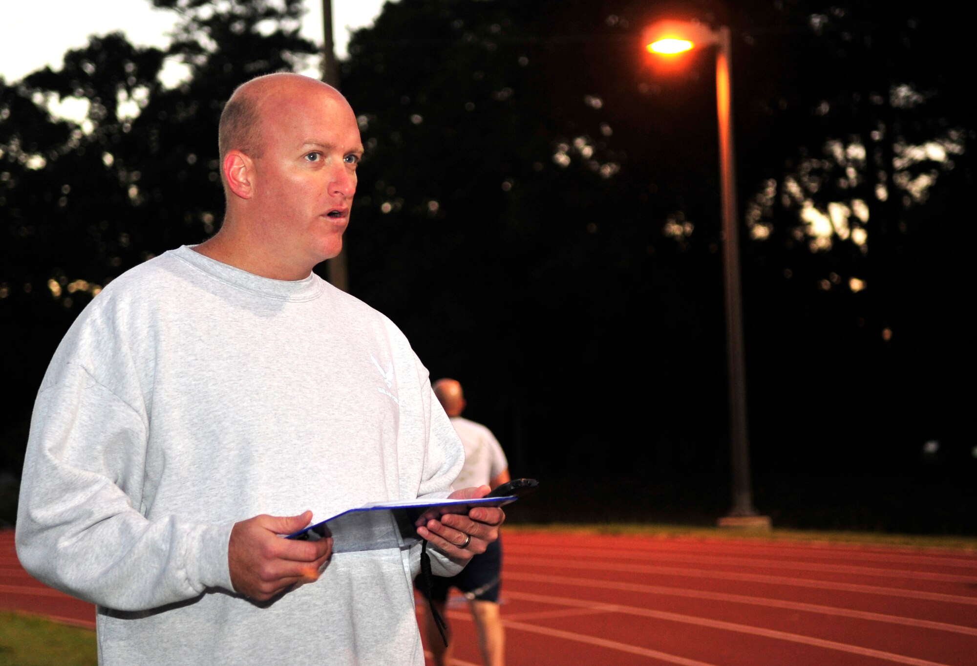 Tech. Sgt. Jeffrey Lash, 4th Force Support Squadron senior professional military education instructor, calls out run times to Airman Leadership School students during a mock physical training test at Seymour Johnson Air Force Base, North Carolina, Oct. 6, 2014. The 4th FSS ALS is composed of five instructors and one commandant who guide students through curriculum over the nearly six-week course. (U.S. Air Force photo/Airman 1st Class Ashley J. Thum)
