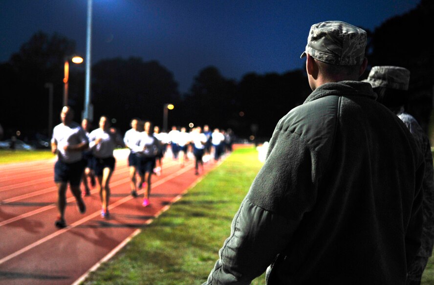 Staff Sgt. Justin Davis and Tech. Sgt. Sandi Townson, 4th Force Support Squadron professional military education instructors, oversee a mock physical training test for Airman Leadership School students at Seymour Johnson Air Force Base, North Carolina, Oct. 6, 2014. Students participate in regular physical training throughout their course and must complete a mock physical training test at the beginning and end of their time in ALS to gauge their progress. (U.S. Air Force photo/Airman 1st Class Ashley J. Thum)