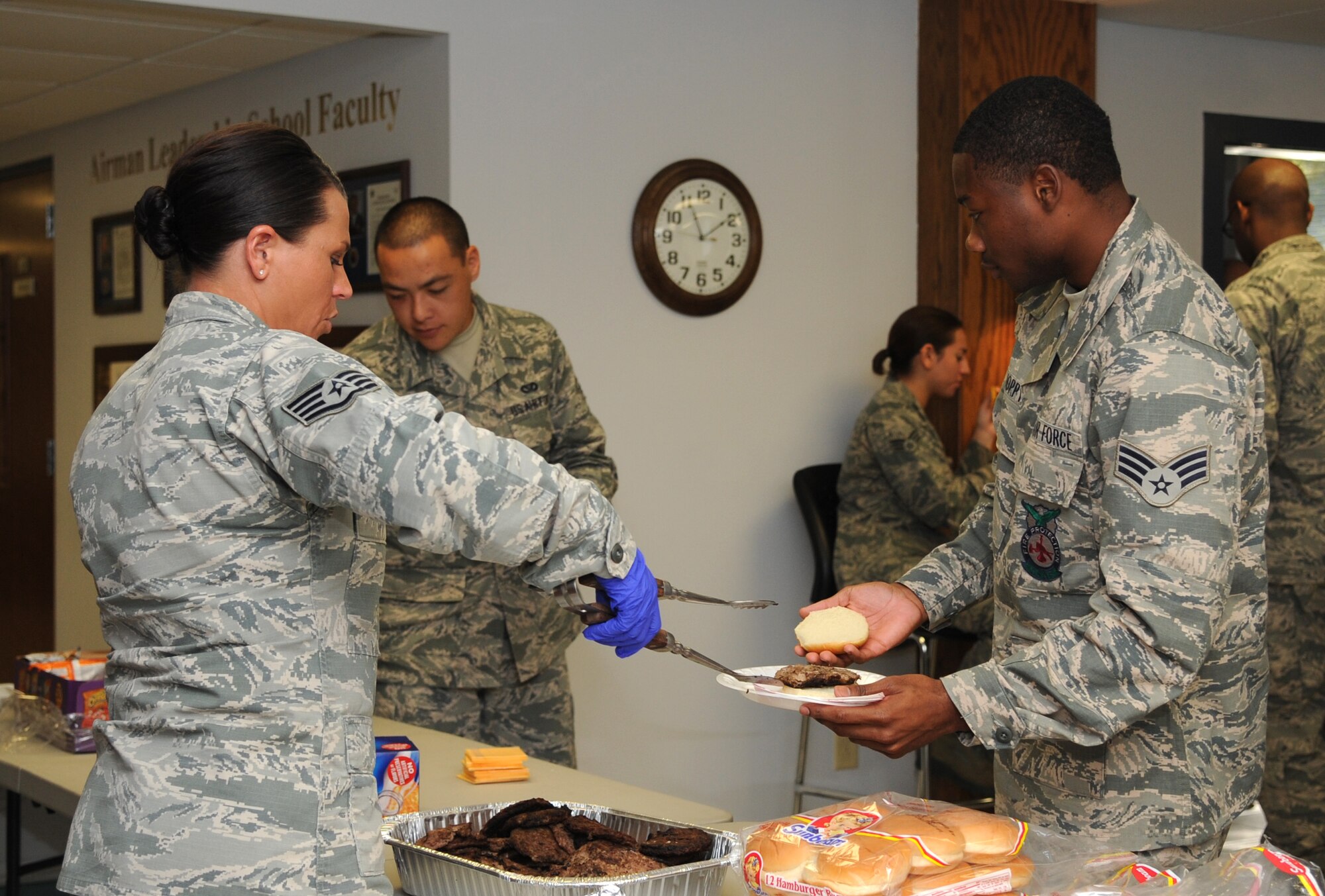 Staff Sgt. Stevi Makripodis, 4th Force Support Squadron professional military education instructor, serves Airman Leadership School students lunch during an icebreaker event at Seymour Johnson Air Force Base, North Carolina, Oct. 16, 2014. ALS is a unique networking opportunity known for fostering lasting friendships between students. (U.S. Air Force photo/Airman 1st Class Ashley J. Thum)