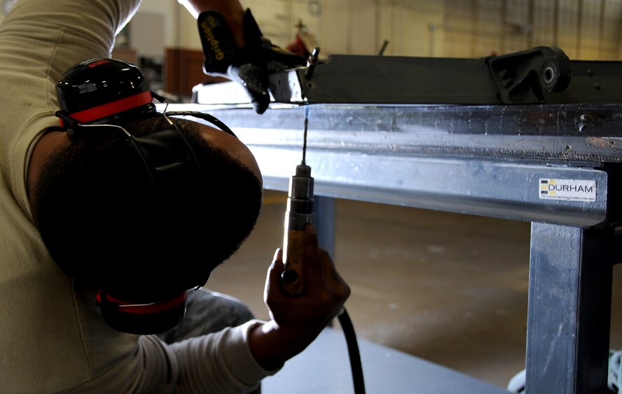 Corey Sims, U.S. Department of Agriculture wildlife biologist, fires a 12-gauge pyrotechnics pistol, used for nonlethal bird removal on Barksdale Air Force Base, La., June 12, 2014. Sims oversees the Bird Aircraft Strike Hazard program at Barksdale and helps implement wildlife damage management to reduce the number of wildlife strikes with aircraft. (U.S. Air Force photo/Staff Sgt. Jason McCasland)