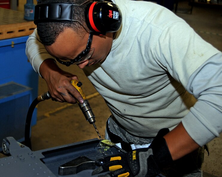 Staff Sgt. Montez Lee, 2nd Maintenance Squadron Aircraft Structural Maintenance craftsman, drills a hole in preparation for a rivet at Barksdale Air Force Base, La., Nov. 13, 2014. Aircraft structures Airmen are responsible for the skin of the B-52H Stratofortress, which includes paint, panel replacement and structural rib repairs. (U.S. Air Force photo/Staff Sgt. Jason McCasland)