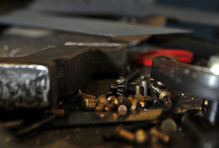 Rivets and bucking bars wait to be used on a B-52H Stratofortress spoiler at Barksdale Air Force Base, La., Nov. 13, 2014. Airmen from the 2nd Maintenance Squadron aircraft structural maintenance shop repair or replace sheet metal and fix loose rivets and cracks on the B-52H Stratofortress. Repairing sheet metal locally saves repair times and costs, which allows the B-52 to complete its mission providing decisive nuclear deterrence and conventional firepower to combatant commanders for global strike operations. (U.S. Air Force photo/Staff Sgt. Jason McCasland)