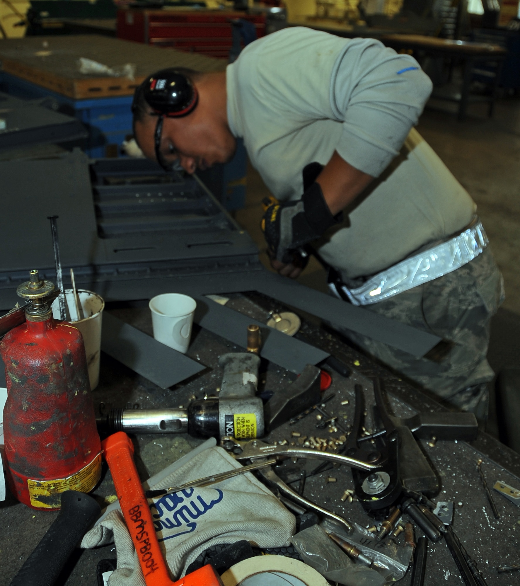 Staff Sgt. Montez Lee, 2nd Maintenance Squadron aircraft structural maintenance craftsman, uses rivets and bucking bars on a B-52H Stratofortress spoiler at Barksdale Air Force Base, La., Nov. 13, 2014. Airmen from the 2nd MXS, aircraft structural maintenance shop repair or replace sheet metal and fix loose rivets and cracks on the B-52. (U.S. Air Force photo/Staff Sgt. Jason McCasland)