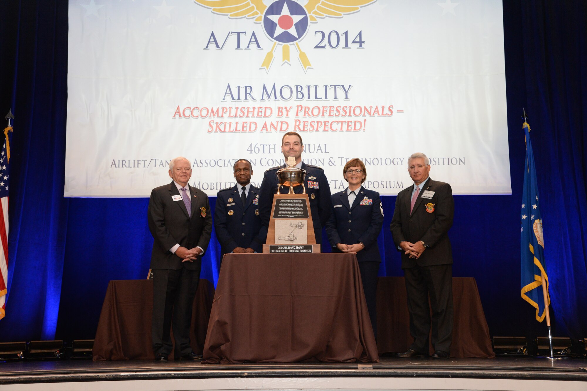 U.S. Air Force Lt. Col. Michael Parks, center, 351st Air Refueling Squadron commander, receives the 2013 Gen. Carl A. Spaatz Trophy on behalf of the 351st ARS Oct. 30, 2014, during the 46th Annual Airlift/Tanker Association Convention and Symposium. The 351st ARS was the first overseas unit to win the trophy which is awarded to the most outstanding air refueling squadron in Air Mobility Command. (Courtesy Photo)