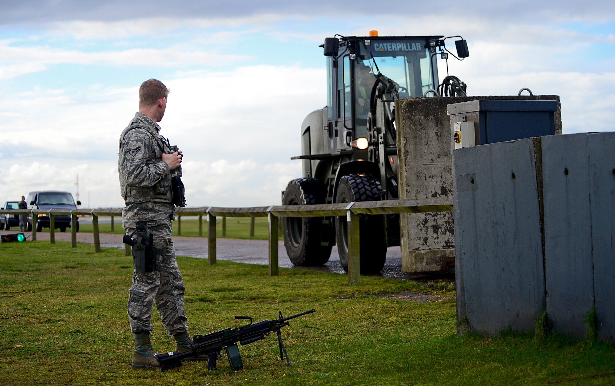 Airman 1st Class Zachary Warden, 48th Security Forces Squadron response force member, oversees a protective barrier movement during his patrol shift at Royal Air Force Lakenheath, England, Nov. 12, 2014. Security forces follow procedural checklists while they patrol sensitive areas and ensure base assets are protected at all times. (U.S. Air Force photo by Senior Airman Erin O’Shea/Released) 