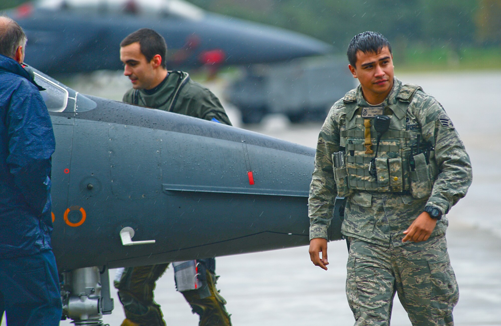 Senior Airman Manuel Garcia, 48th Security Forces Squadron response force leader, provides security while a French aircraft refuels on the flightline at Royal Air Force Lakenheath, England, Nov. 12, 2014. A security forces member must oversee foreign transient aircraft to ensure they abide by all security measures. (U.S. Air Force photo by Senior Airman Erin O’Shea/Released) 