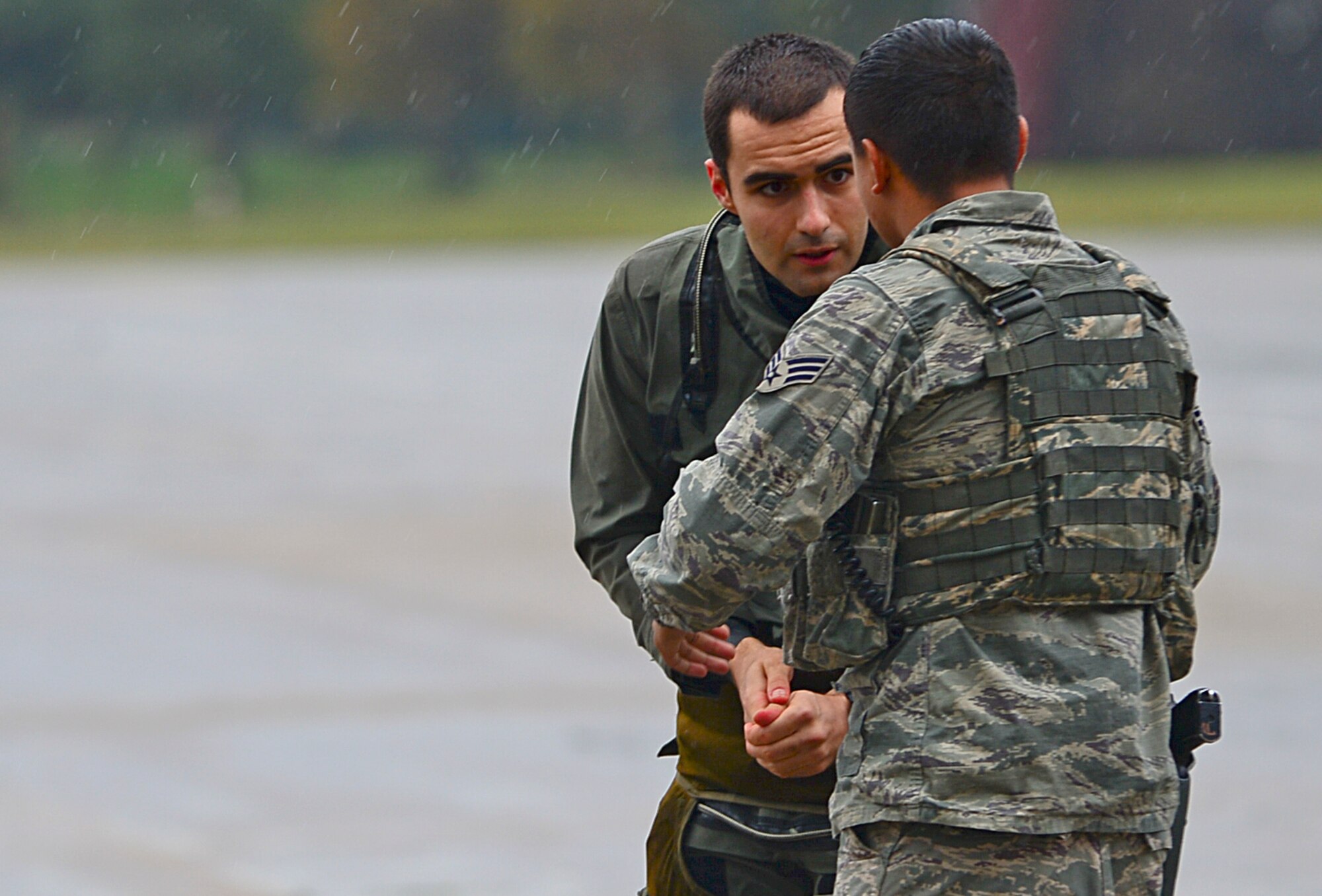 Senior Airman Manuel Garcia, 48th Security Forces Squadron response force leader, engages with a French pilot who arrived for refueling at Royal Air Force Lakenheath, England, Nov. 12, 2014. A security forces member must oversee foreign transient aircraft to ensure they abide by all security measures. (U.S. Air Force photo by Senior Airman Erin O’Shea/Released) 