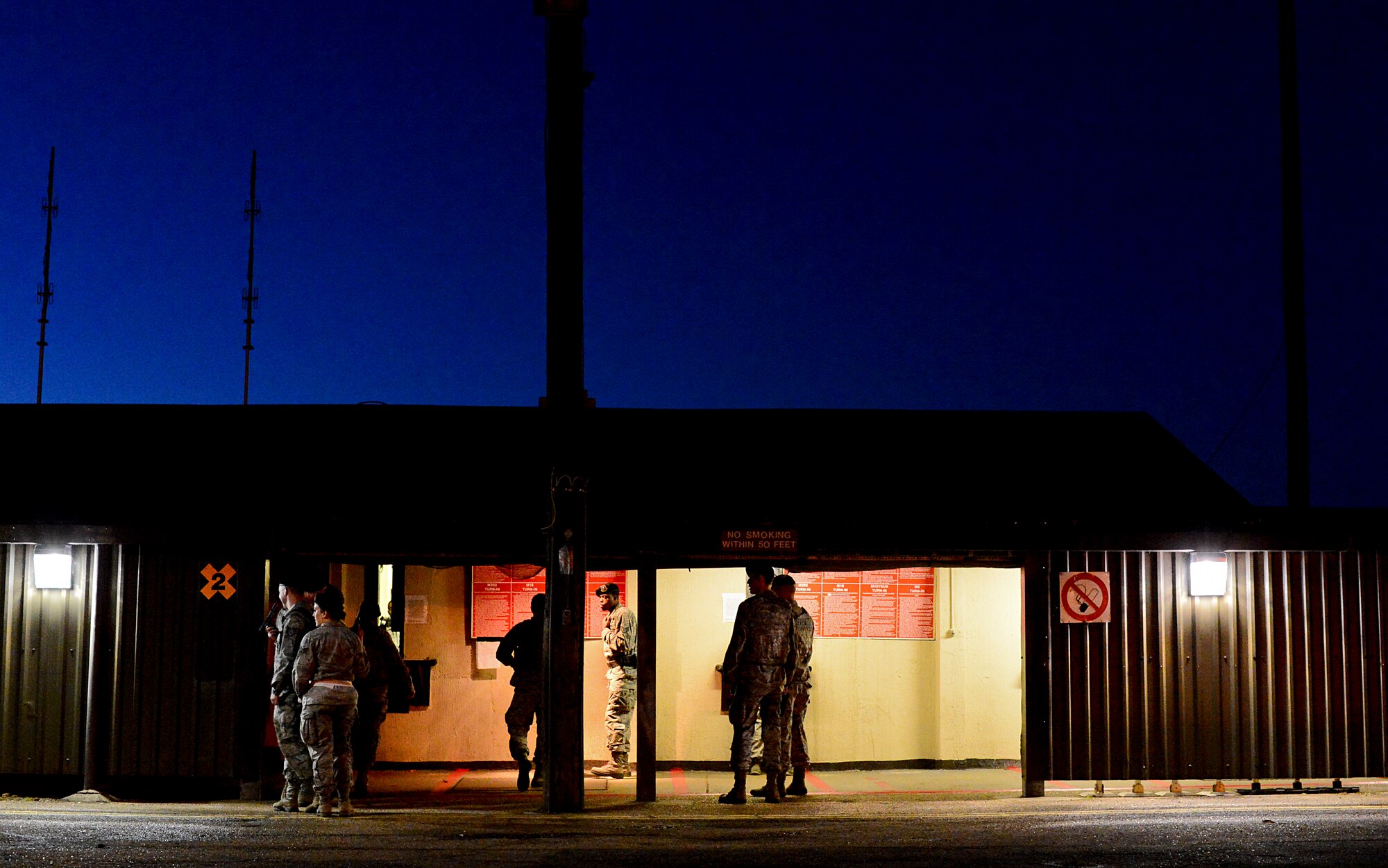 Airmen assigned to the 48th Security Forces Squadron prepare for a shift change at the armory on Royal Air Force Lakenheath, England, Nov. 14, 2014. The squadron was first activated July 10, 1952, and re-designated as the 48th Security Forces Squadron in 1997. (U.S. Air Force photo by Senior Airman Erin O’Shea/Released)   