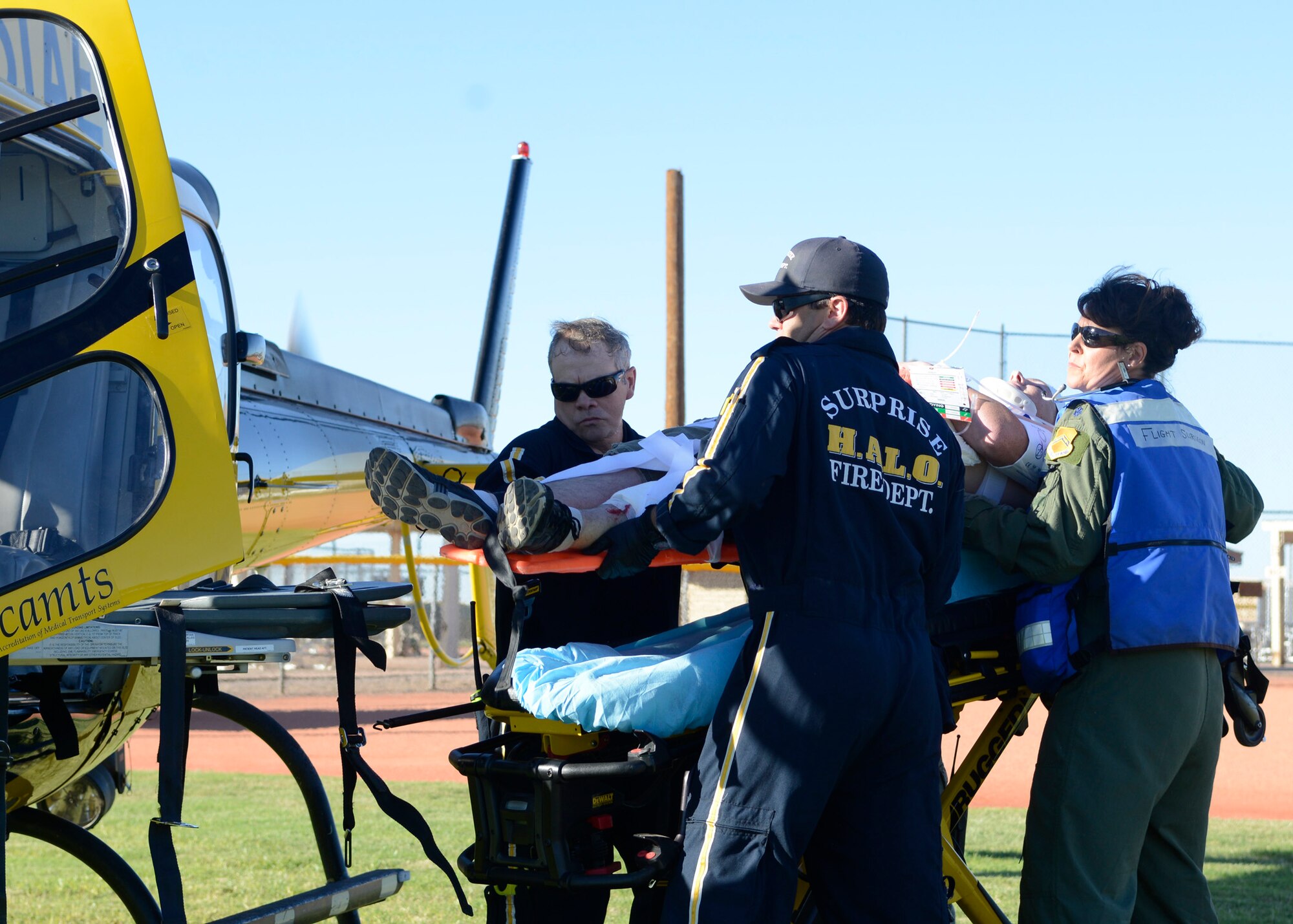 Members of the 56th Medical Group and Southwest Med Evac air ambulance team members prepare to air evacuate a simulated victim during the exercise Nov. 5 at Luke Air Force Base. The exercise was conducted for first responders, base personnel and local agencies to practice real-world events. (U.S. Air Force photo/Senior Airman Devante Williams)