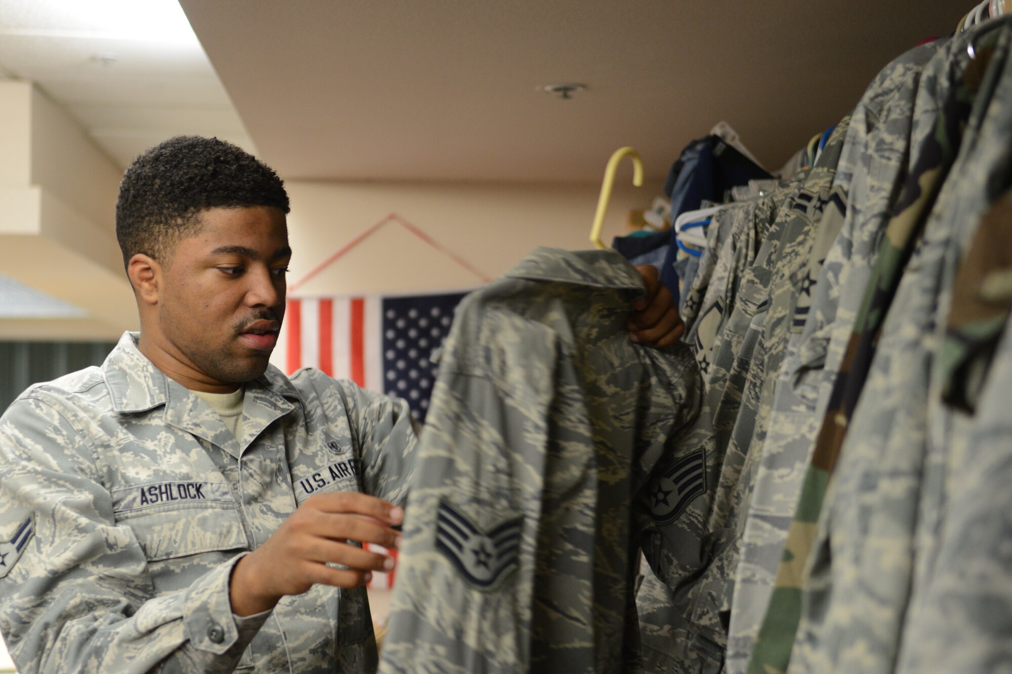 Airman 1st Class Jordan Ashlock, 56th Medical Operations Squadron mental health technician, searches for the right uniform Nov. 4 at Luke. Enlisted and officers regardless of rank can pick up uniforms from the Airman’s Attic for free. (U.S. Air Force photo/Airman 1st Class Cory Gossett)