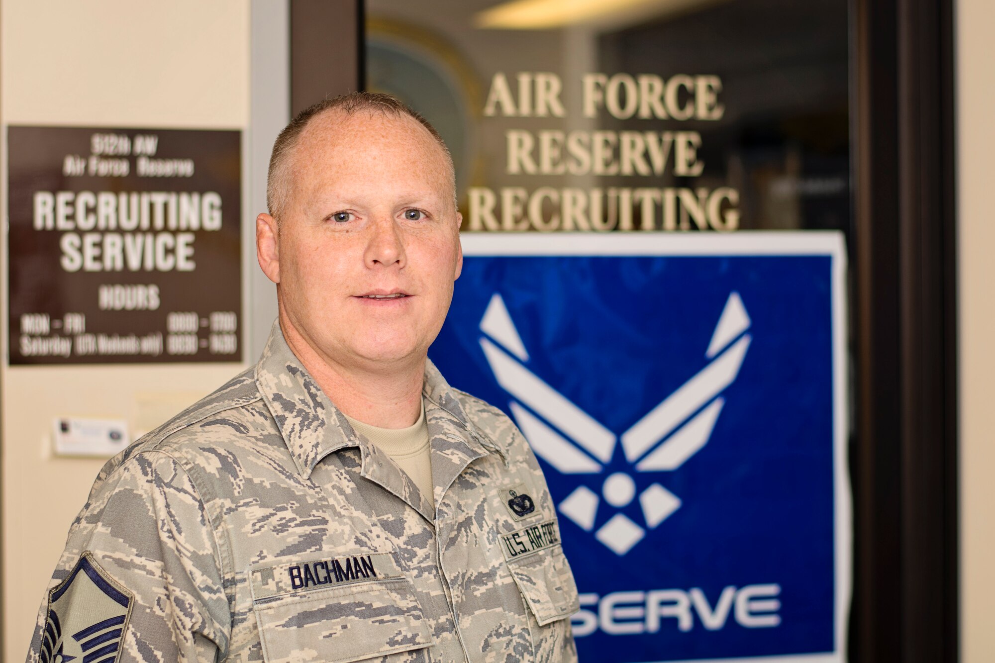 Master Sgt. Ken Bachman, the Air Force Reserve in-service recruiter at Dover Air Force Base, Del., stands outside the entrance to his office located inside the Visitors Center. Bachman is available weekdays from 8:30 a.m. - 5:00 p.m. to assist Airmen with Palace Front and Palace Chase options and their transition into the AF Reserve. (U.S. Air Force photo/Capt. Bernie Kale)
