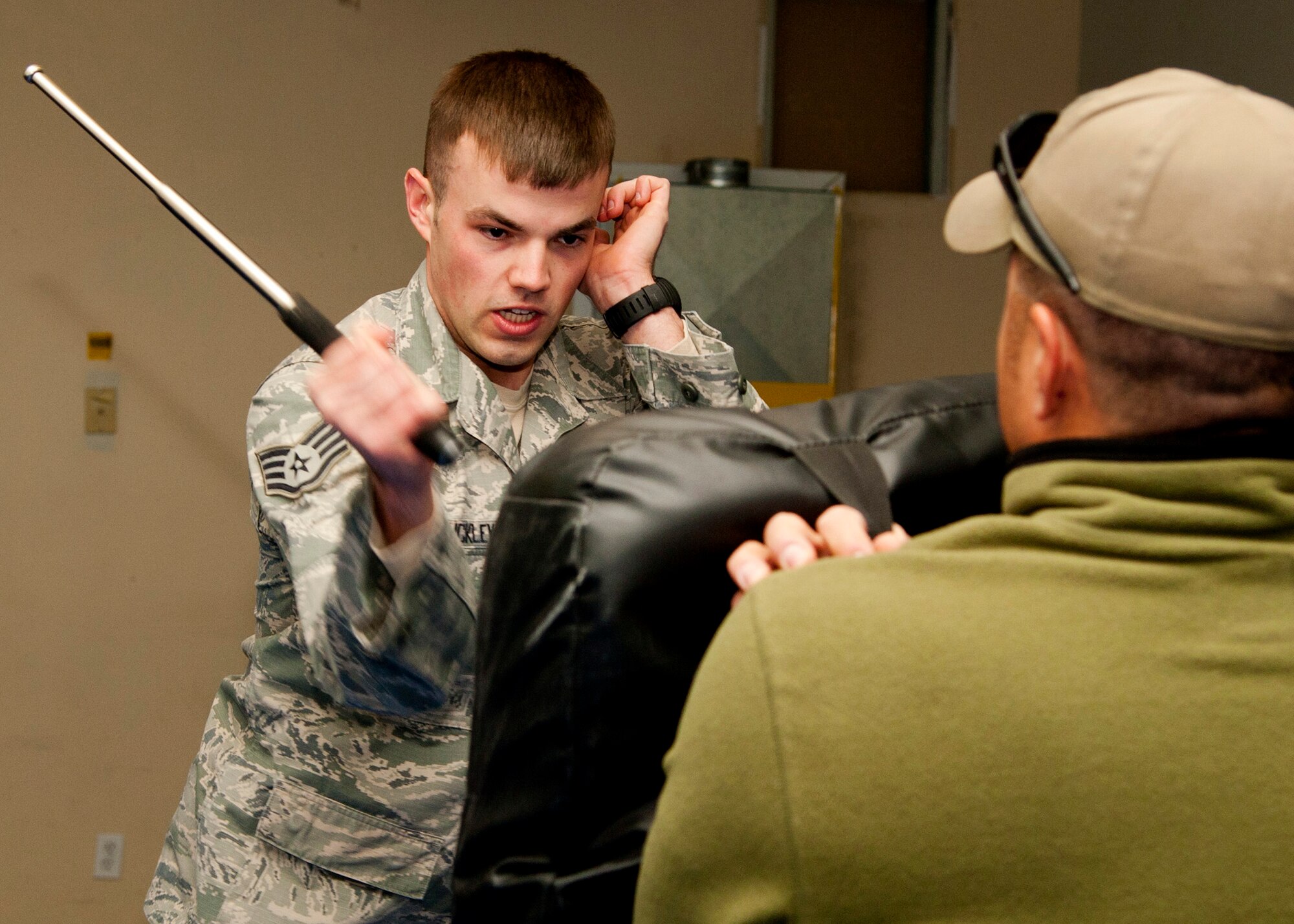 PETERSON AIR FORCE BASE, Colo. – Staff Sgt. Morgan Buckley, 21st Security Forces Squadron patrolman, strikes a combative bag with an expandable baton during baton training Nov. 13, 2014. Members of the 21st SFS participate in yearly training for the secondary weapon, the expandable baton. It is one of a few ways to control of a situation and prevent unnecessary injuries to not only the subject but also themselves. (U.S. Air Force photo by Senior Airman Tiffany DeNault)