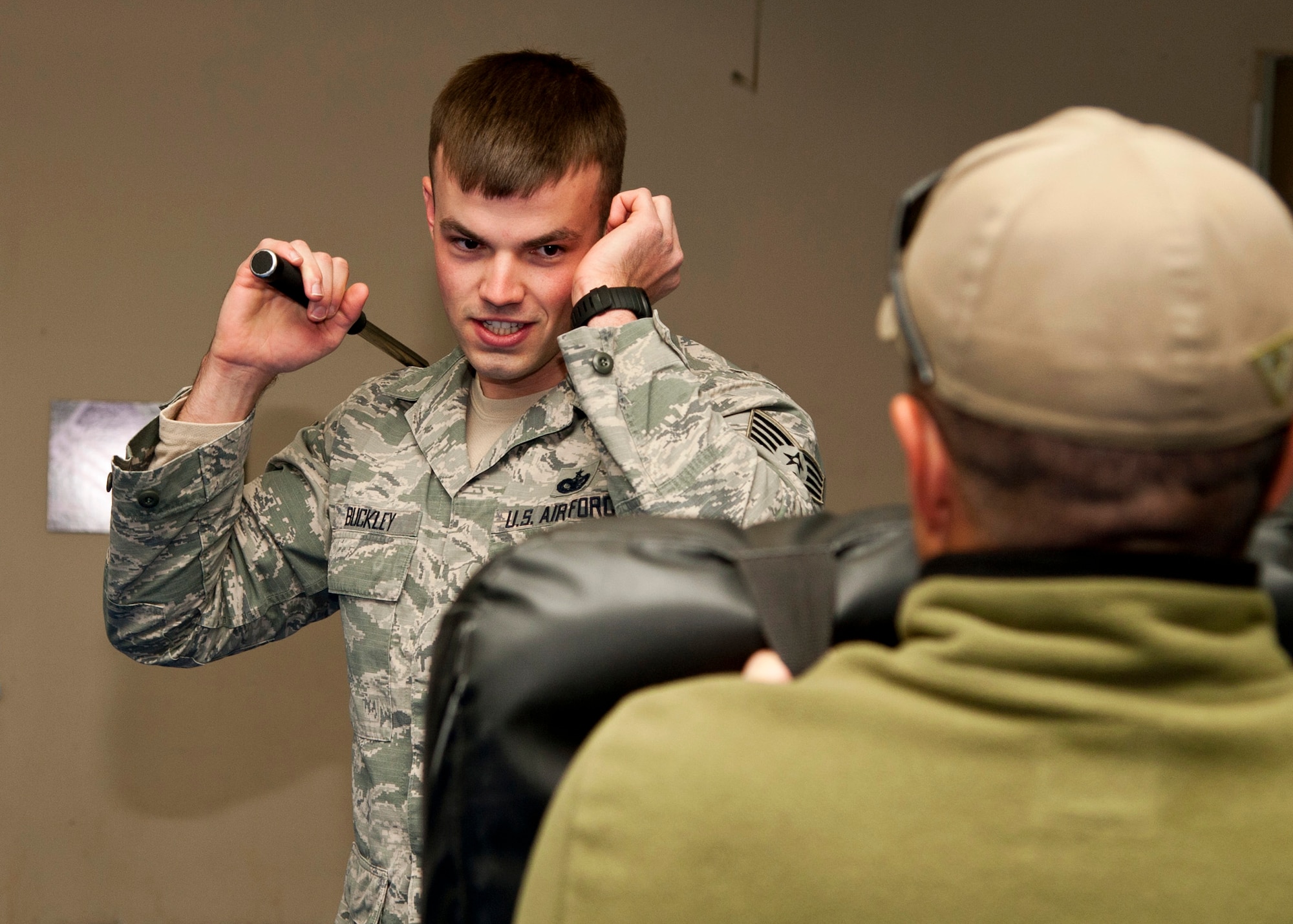 PETERSON AIR FORCE BASE, Colo. – Staff Sgt. Morgan Buckley, 21st Security Forces Squadron patrolman, strikes a combative bag with an expandable baton during baton training Nov. 13, 2014. Members of the 21st SFS participate in yearly training for the secondary weapon, the expandable baton. It is one of a few ways to control of a situation and prevent unnecessary injuries to not only the subject but also themselves. (U.S. Air Force photo by Senior Airman Tiffany DeNault)