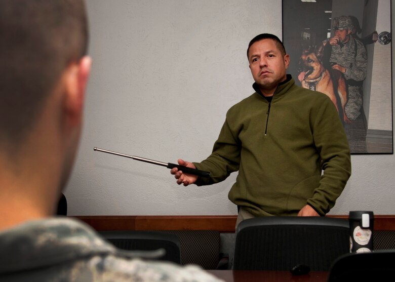 PETERSON AIR FORCE BASE, Colo. - Isaac Lopez, 21st Security Forces Squadron training supervisor, provides baton training to Staff Sgt. Morgan Buckley, a 21st SFS patrolman, Nov. 13, 2014. Members of the 21st SFS participate in yearly training for the secondary weapon, the expandable baton. It is one of a few ways to control of a situation and prevent unnecessary injuries to not only the subject but also themselves. (U.S. Air Force photo by Senior Airman Tiffany DeNault)