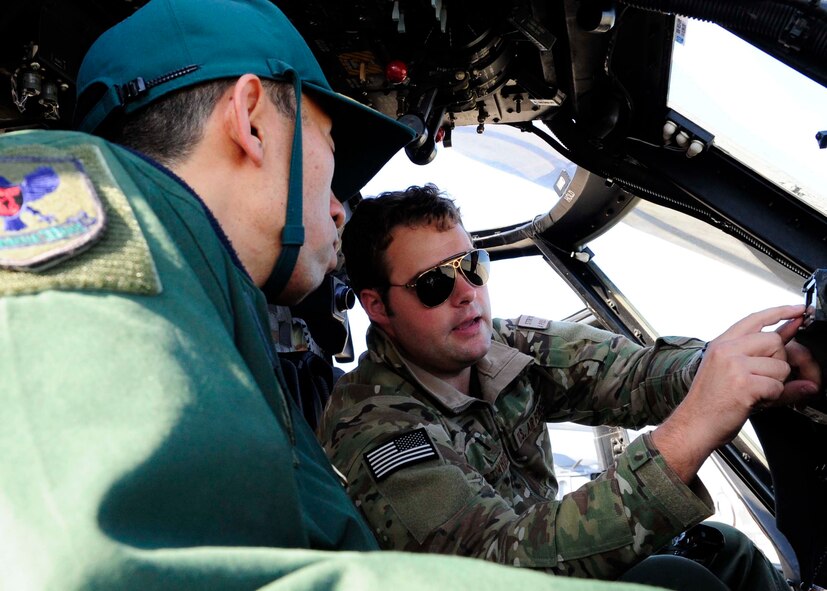 Japan Air Rescue Wing Operations Group Commander Col. Yutaka Harada sits inside the cockpit of an HH-60G Pave Hawk with U.S. Air Force 1st Lt. Dirk Strykowski, 33rd Rescue Squadron pilot, on Komatsu Air Base, Japan, Nov. 12, 2014. Harada visited Komatsu Air Base during Exercise Keen Sword, a biennial joint-bilateral exercise between the U.S. military and the Japan Self Defense Force. The 33rd RQS is assigned to Kadena Air Base, Japan. (U.S. Air Force photo by 2nd Lt. Erik Anthony/Released) 