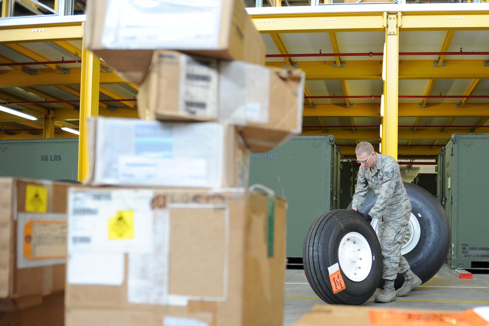 Staff Sgt. Kyle Sarringer, 86th LRS supply journeyman, moves a C-130J Super Hercules wheel on Ramstein Air Base, Germany, Sep. 24, 2014. The 86th LRS is a 24-hour operation providing fuel, deployment necessities and equipment for all inbound and outbound aircraft and military members. (U.S. Air Force photo/Airman 1st Class Michael Stuart)