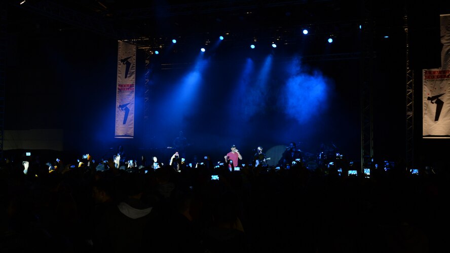 Members of the Spangdahlem community record country music star Darius Rucker's performance on their smart phones during a concert Nov. 14, 2014, at Hangar One at Spangdahlem Air Base, Germany. Navy and Armed Forces Entertainment sponsored the concert as part of a worldwide tour for service members and their families. (U.S. Air Force photo by Airman 1st Class Dylan Nuckolls/Released)