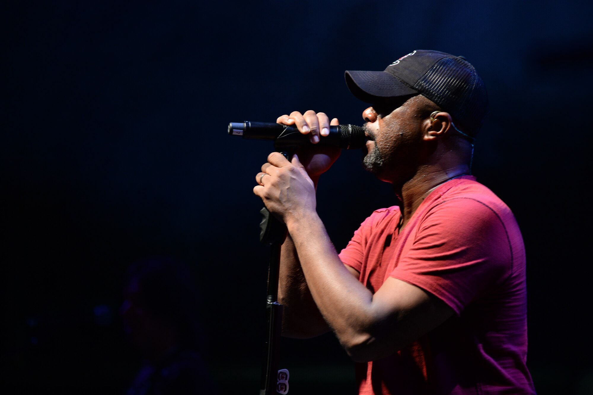 Country musician Darius Rucker sings during a 90-minute performance during a concert Nov. 14, 2014, at Hangar One at Spangdahlem Air Base, Germany. Rucker performed songs as part of his 2014 Europe tour. (U.S. Air Force photo by Airman 1st Class Dylan Nuckolls/Released)